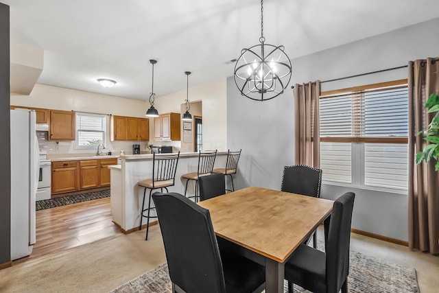 861 Summerville Dr, Delaware, OH 43015 - dining space featuring a chandelier and light colored carpet