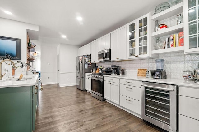 112 Oak Hill Ave, Delaware, OH 43015 - kitchen with wine cooler, appliances with stainless steel finishes, backsplash, dark wood-style flooring, and recessed lighting