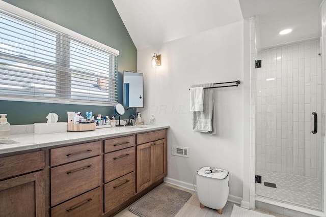 112 Oak Hill Ave, Delaware, OH 43015 - bathroom with a shower stall, double vanity, vaulted ceiling, tile patterned flooring, and recessed lighting