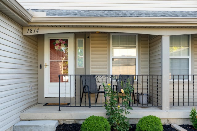 1814 Bennigan Dr Unit 88B, Hilliard, OH 43026 - doorway to property featuring a porch and a shingled roof