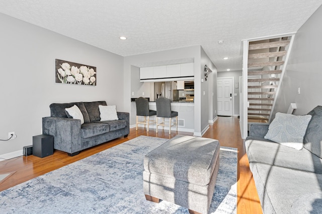 1814 Bennigan Dr Unit 88B, Hilliard, OH 43026 - living room with wood finished floors, stairs, a textured ceiling, and recessed lighting
