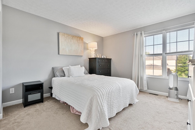 1814 Bennigan Dr Unit 88B, Hilliard, OH 43026 - bedroom featuring light carpet and a textured ceiling
