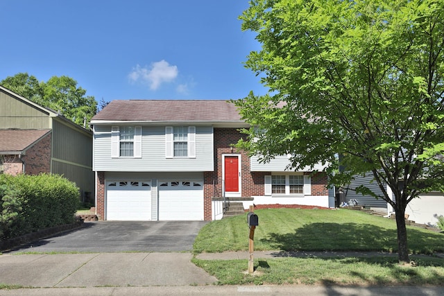 7805 Kiowa Way, Columbus, OH 43085 - raised ranch featuring brick siding, driveway, an attached garage, and a front yard