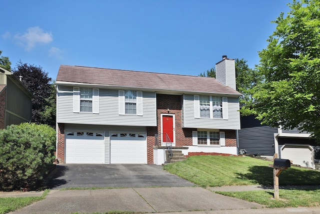 7805 Kiowa Way, Columbus, OH 43085 - split foyer home with brick siding, asphalt driveway, a garage, and a front yard