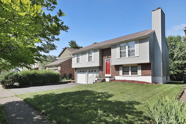 7805 Kiowa Way, Columbus, OH 43085 - raised ranch featuring brick siding, an attached garage, a front yard, a chimney, and concrete driveway
