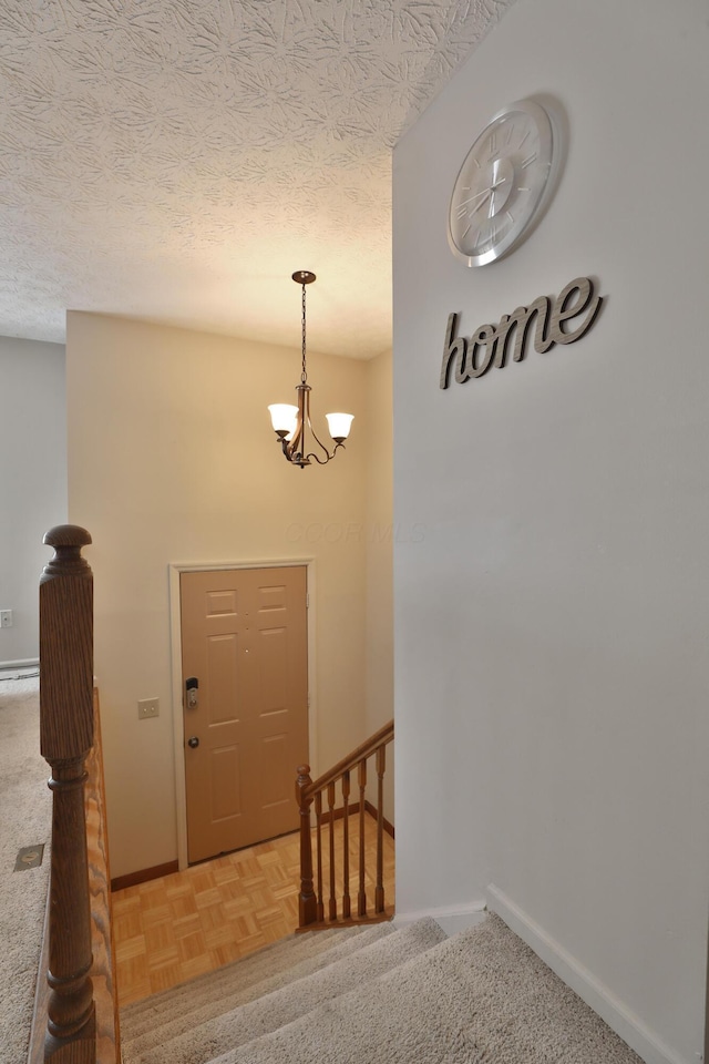 7805 Kiowa Way, Columbus, OH 43085 - stairway featuring a chandelier and a textured ceiling
