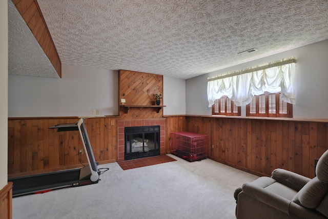 7805 Kiowa Way, Columbus, OH 43085 - living room featuring wood walls, wainscoting, carpet floors, and a tile fireplace