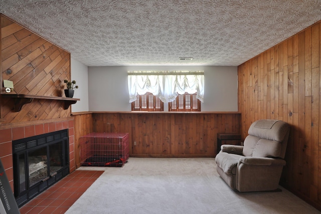 7805 Kiowa Way, Columbus, OH 43085 - sitting room with wood walls, a tiled fireplace, a wainscoted wall, and carpet flooring