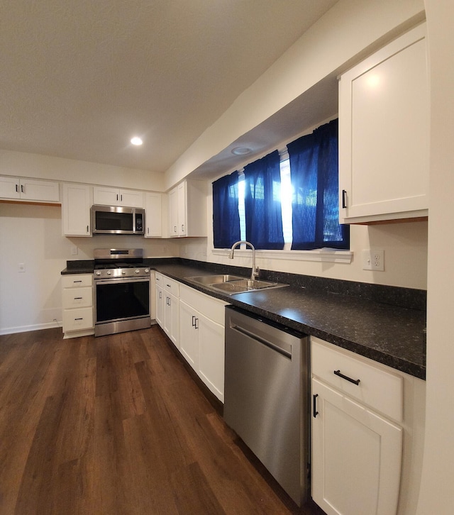 1444 Bolenhill Ave, Columbus, OH 43229 - kitchen featuring appliances with stainless steel finishes, dark wood-type flooring, white cabinets, dark countertops, and recessed lighting