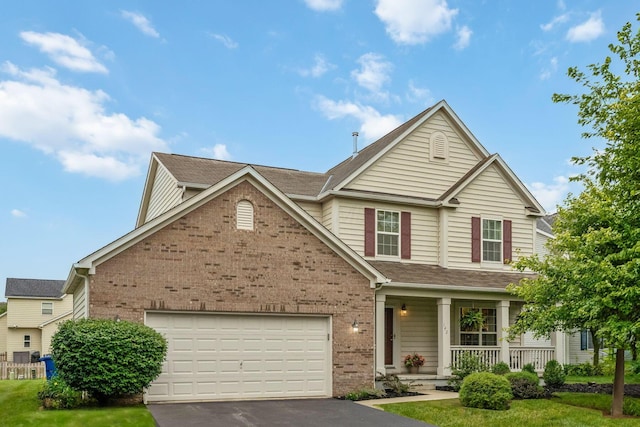 142 Blakemore Dr, Delaware, OH 43015 - traditional-style home featuring brick siding, a porch, driveway, and a garage