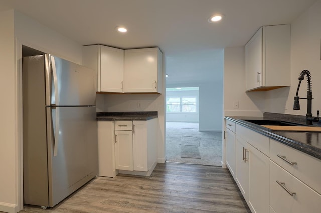 570 E Water St, Chillicothe, OH 45601 - kitchen featuring freestanding refrigerator, white cabinets, light wood-style flooring, and recessed lighting