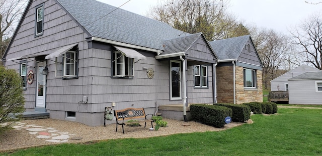 730 W Marion St, Mount Gilead, OH 43338 - view of front of house with a shingled roof, a front yard, and stone siding