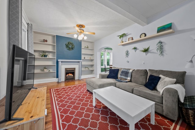 116 W Longview Ave, Columbus, OH 43202 - living area with built in features, wood finished floors, arched walkways, ceiling fan, and a fireplace