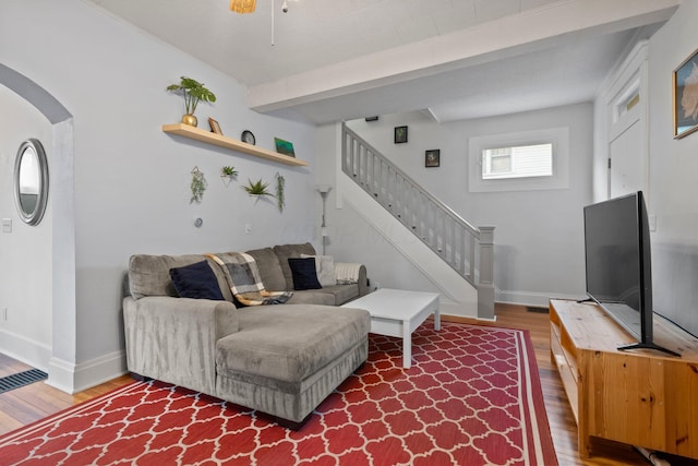 116 W Longview Ave, Columbus, OH 43202 - living room with wood finished floors, stairs, arched walkways, and beamed ceiling
