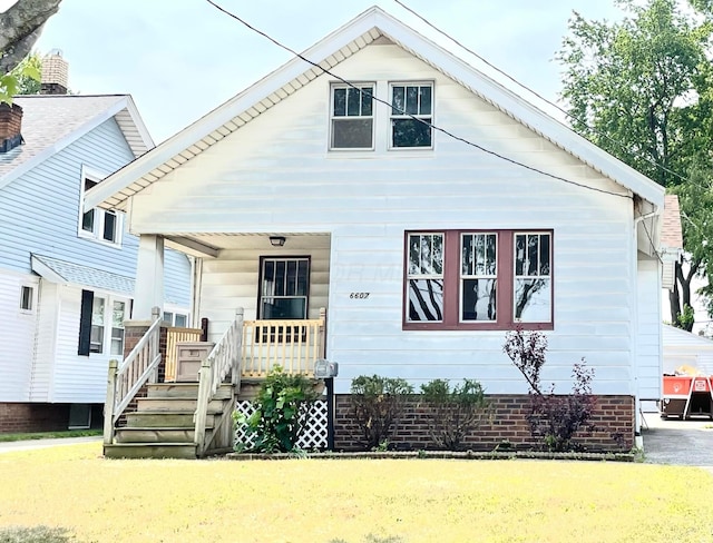 6607 Vandalia Ave, Cleveland, OH 44144 - view of front of house with covered porch and a front lawn