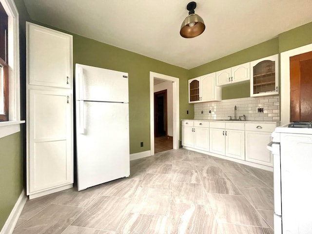 6607 Vandalia Ave, Cleveland, OH 44144 - kitchen featuring white appliances, glass insert cabinets, white cabinetry, and tasteful backsplash