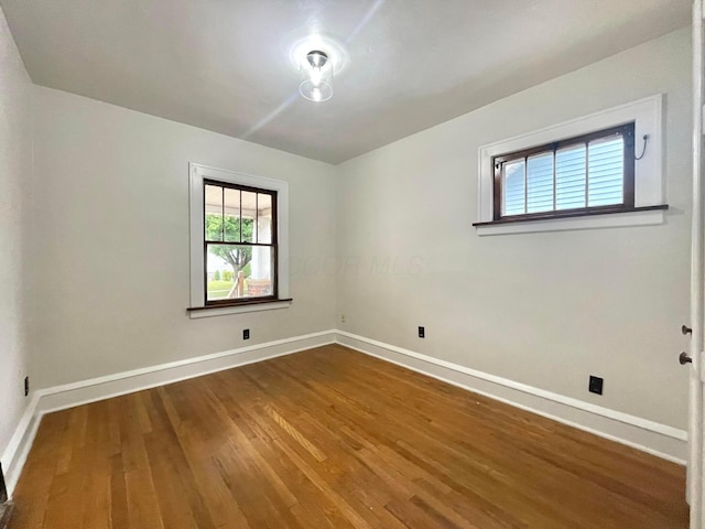 6607 Vandalia Ave, Cleveland, OH 44144 - spare room featuring baseboards and wood finished floors