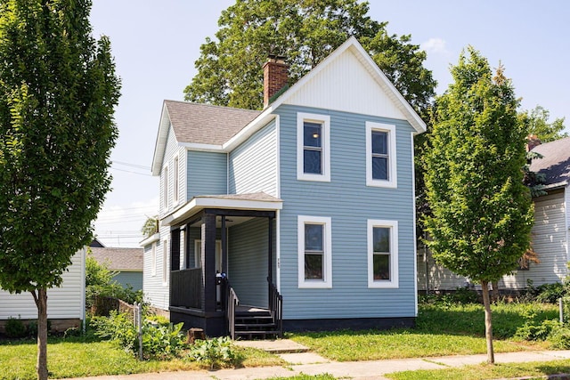 765 Campbell Ave, Columbus, OH 43222 - view of front of home featuring covered porch, a chimney, a front yard, and roof with shingles