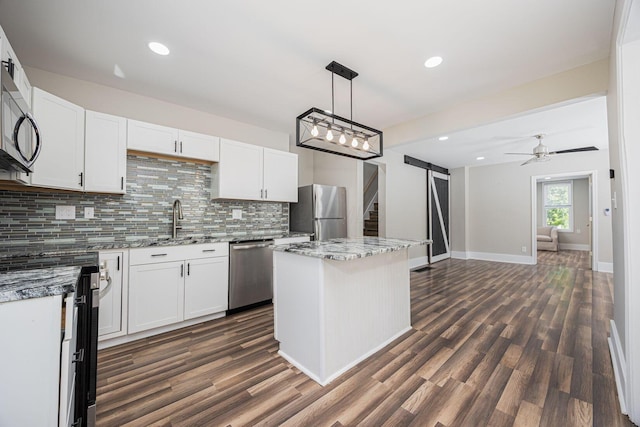 765 Campbell Ave, Columbus, OH 43222 - kitchen featuring stainless steel appliances, backsplash, dark wood-type flooring, a center island, and recessed lighting