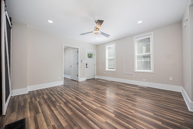765 Campbell Ave, Columbus, OH 43222 - spare room with dark wood-style flooring, ceiling fan, recessed lighting, and a barn door