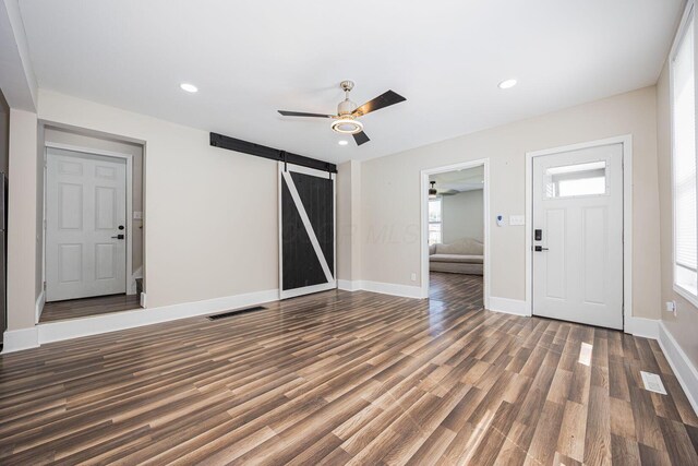 765 Campbell Ave, Columbus, OH 43222 - entrance foyer featuring a barn door, ceiling fan, wood finished floors, plenty of natural light, and recessed lighting