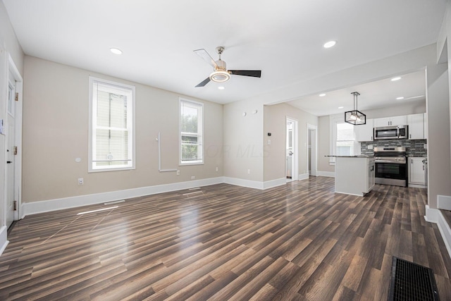 765 Campbell Ave, Columbus, OH 43222 - unfurnished living room with dark wood finished floors, a ceiling fan, and recessed lighting