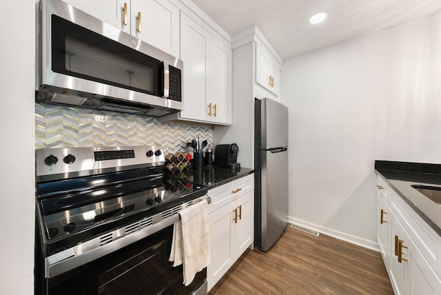 1768 Lake Meadow Dr Unit 1768H, Reynoldsburg, OH 43068 - kitchen with appliances with stainless steel finishes, decorative backsplash, dark wood-style flooring, white cabinetry, and recessed lighting