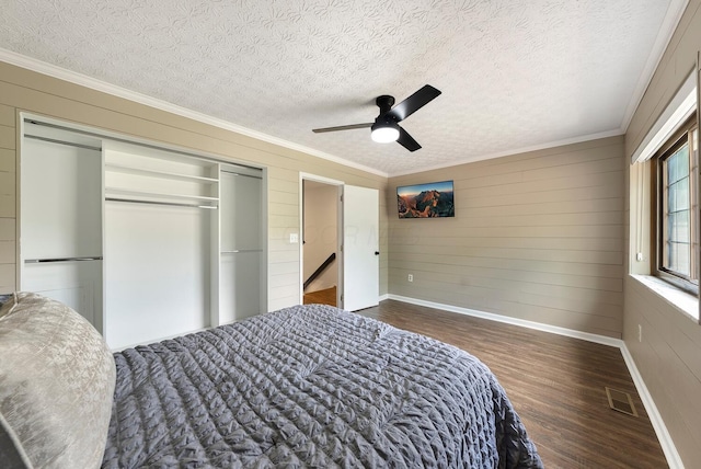 1768 Lake Meadow Dr Unit 1768H, Reynoldsburg, OH 43068 - bedroom featuring wood finished floors, ornamental molding, a closet, a textured ceiling, and wood walls