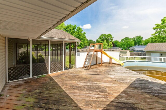 1282 Lawndale Rd, Marion, OH 43302 - wooden deck featuring a playground, a fenced backyard, and a sunroom