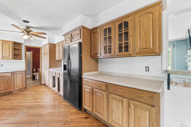 1282 Lawndale Rd, Marion, OH 43302 - kitchen with black refrigerator with ice dispenser, ceiling fan, glass insert cabinets, open shelves, and light countertops