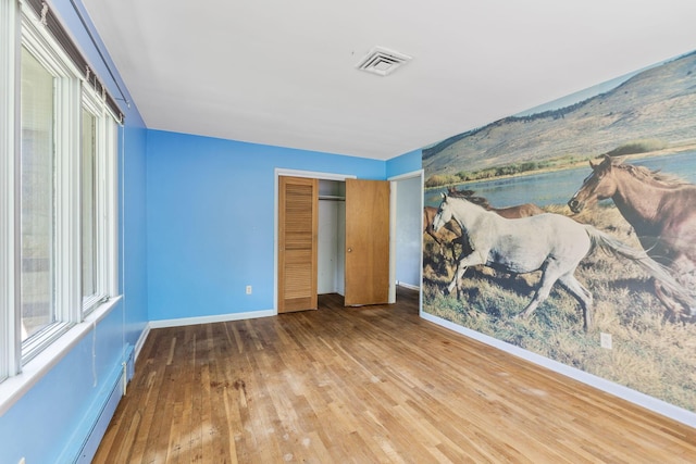 1282 Lawndale Rd, Marion, OH 43302 - unfurnished bedroom with hardwood / wood-style floors, baseboard heating, and a closet