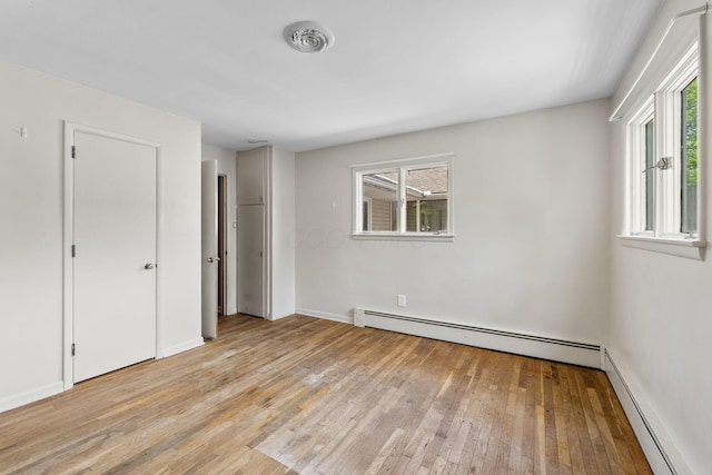 1282 Lawndale Rd, Marion, OH 43302 - unfurnished bedroom with baseboard heating, light wood-style floors, and multiple windows