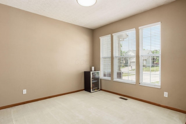 5899 Cove Point Ct, Columbus, OH 43228 - empty room with beverage cooler and light colored carpet