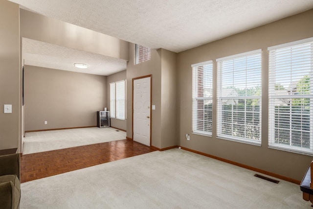 5899 Cove Point Ct, Columbus, OH 43228 - carpeted foyer featuring baseboards and a textured ceiling