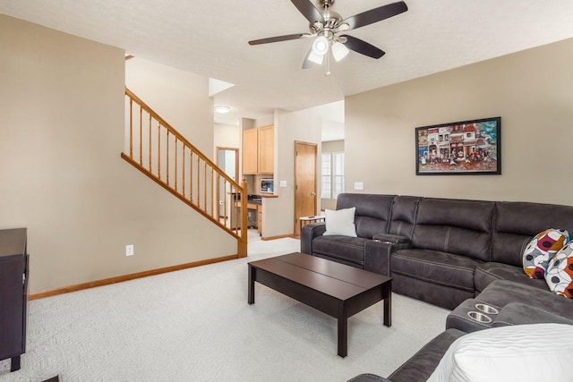 5899 Cove Point Ct, Columbus, OH 43228 - living area with stairway, light colored carpet, and a ceiling fan