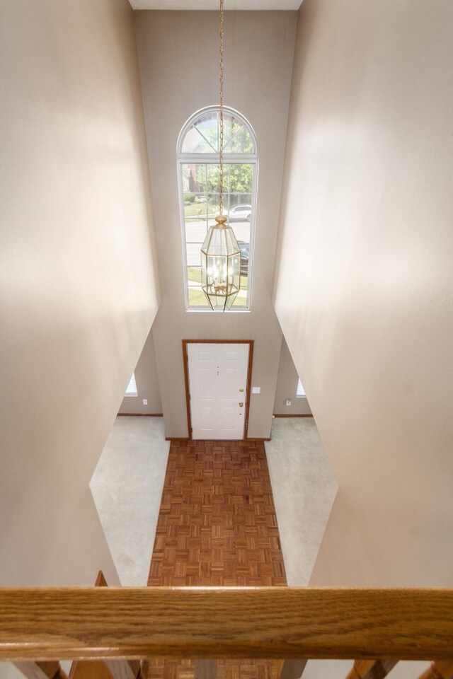 5899 Cove Point Ct, Columbus, OH 43228 - entrance foyer featuring a chandelier, carpet floors, and a high ceiling