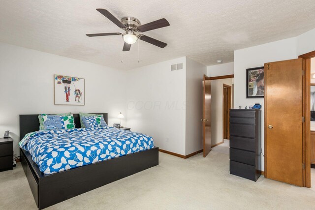 5899 Cove Point Ct, Columbus, OH 43228 - bedroom featuring light carpet, a textured ceiling, and ceiling fan