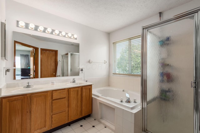 5899 Cove Point Ct, Columbus, OH 43228 - bathroom with a stall shower, a bath, double vanity, and a textured ceiling