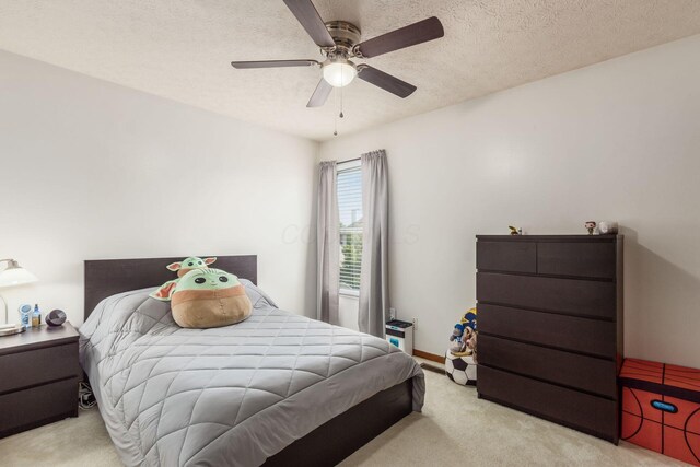 5899 Cove Point Ct, Columbus, OH 43228 - bedroom with carpet, a textured ceiling, and a ceiling fan