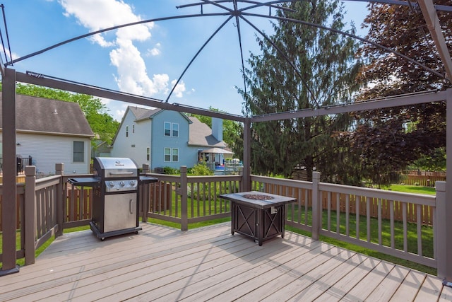5899 Cove Point Ct, Columbus, OH 43228 - wooden deck with grilling area, a fire pit, a lawn, and a residential view