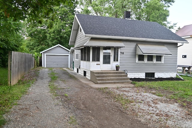 70 Cherry St, Newark, OH 43055 - bungalow-style house with an outbuilding, a chimney, a shingled roof, a garage, and entry steps