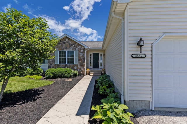 3582 Panhandle Rd, Delaware, OH 43015 - property entrance with an attached garage and stone siding