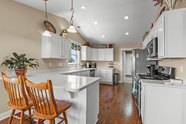 3582 Panhandle Rd, Delaware, OH 43015 - kitchen featuring appliances with stainless steel finishes, a peninsula, vaulted ceiling, recessed lighting, and light countertops
