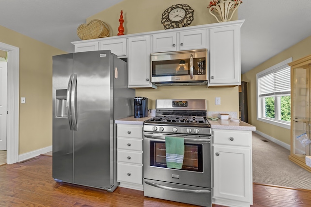 3582 Panhandle Rd, Delaware, OH 43015 - kitchen featuring stainless steel appliances, light countertops, white cabinets, and wood finished floors