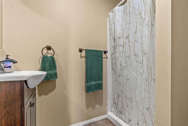 3582 Panhandle Rd, Delaware, OH 43015 - full bath with vanity, curtained shower, and wood finished floors