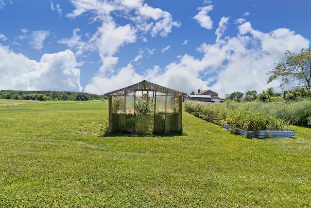 3582 Panhandle Rd, Delaware, OH 43015 - view of green lawn with an exterior structure, an outbuilding, and a garden