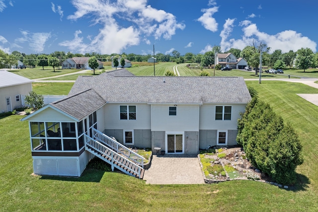 3582 Panhandle Rd, Delaware, OH 43015 - rear view of property with a sunroom, a patio area, and a lawn