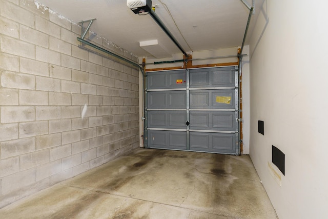114 E Mound St Unit 1, Columbus, OH 43215 - garage featuring a garage door opener and concrete block wall