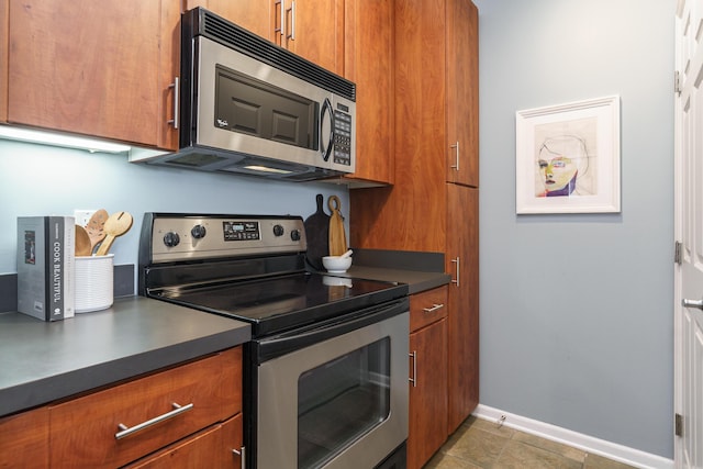 114 E Mound St Unit 1, Columbus, OH 43215 - kitchen with appliances with stainless steel finishes and brown cabinetry