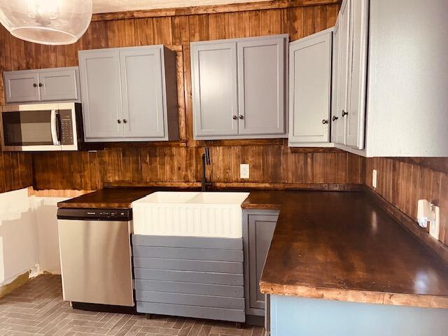 121 Maple St, London, OH 43140 - kitchen featuring stainless steel appliances and wood walls